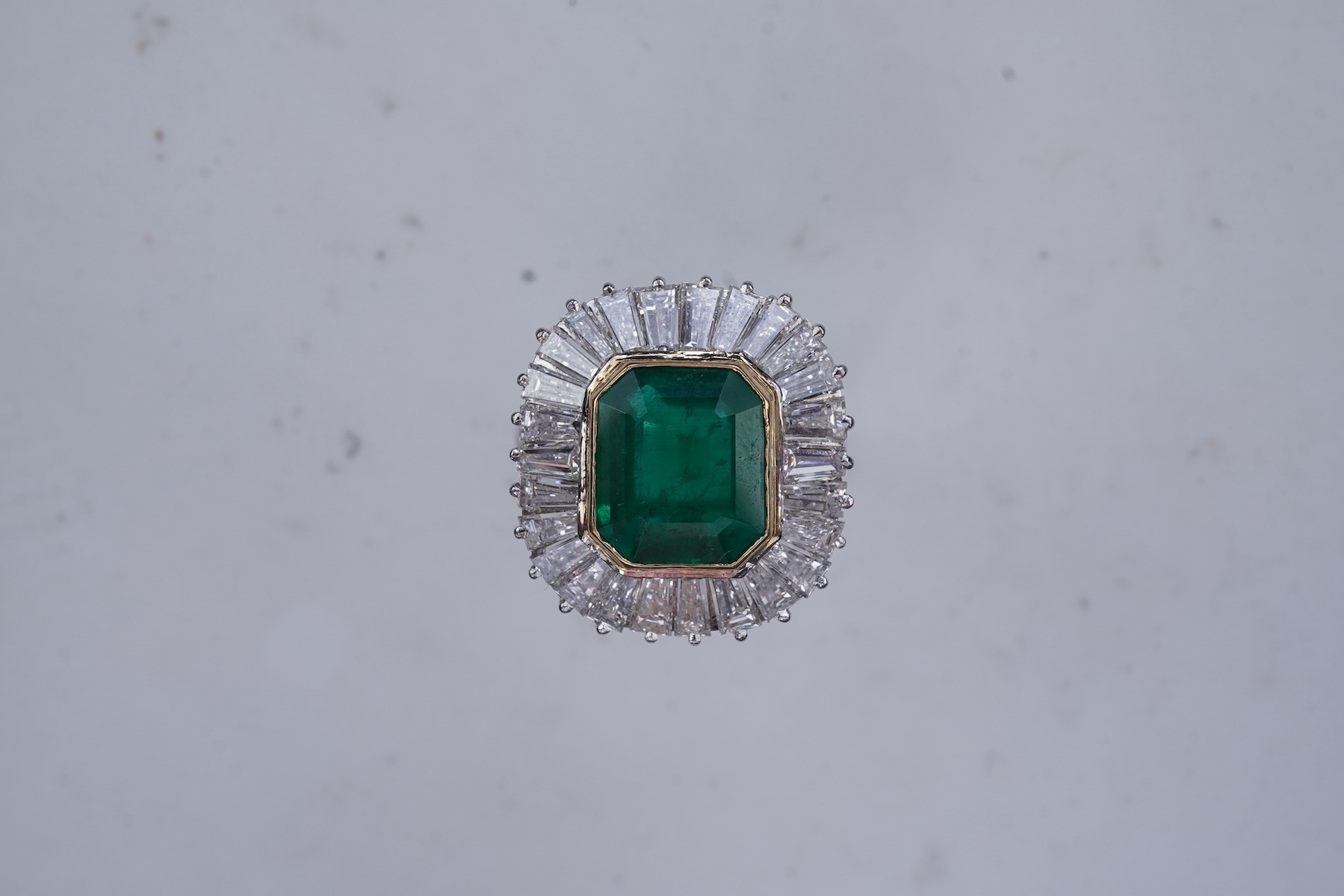 An emerald and diamond ring